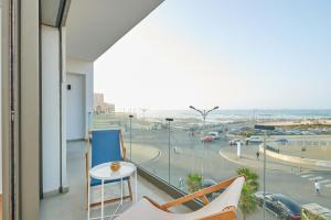 a balcony with a table and a view of the beach at Apartment Sea View B7 - Mosquée Hassan II - By TheCasaEdition in Casablanca