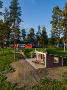 a small house with a deck in a field at Lomatalo Honkamäki 