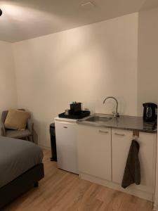 a kitchen with a sink and a counter top at Studio in the city center of Leeuwarden in Leeuwarden