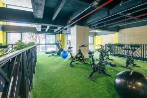 a gym with several exercise bikes in a room at First Class Hotel in Medellín