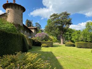 a house with a brick tower in a garden at Manoir de Tourville in Les Halles +19 photos