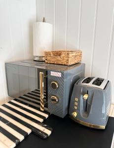 a toaster and a toaster on a table at Beautiful 1-Bed Cabin in Hayling Island in South Hayling