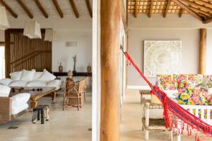 two views of a living room and a dining room at Casa Mandala Corumbau in Corumbau