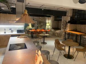 a kitchen with a bunch of tables and chairs at Leicester City Center - Sauna Pool Gym in Leicester