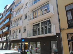 a tall building with balconies on a city street at ABC Apartment in Blankenberge