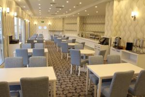 a row of tables and chairs in a waiting room at White Line Boutique Hotel in Elazığ