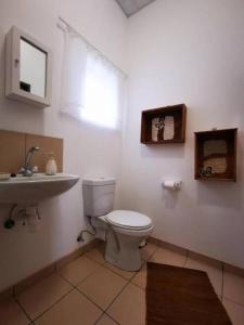 a bathroom with a toilet and a sink at Leather and Lace & a Suitcase in Groutfontein