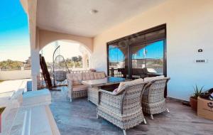 d'une terrasse avec des chaises en osier et une table. dans l'établissement Villa white, à Antalya