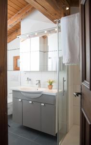 a bathroom with a sink and a mirror at Holiday flat with Jacuzzi for 6 persons-Lenzerheide in Lenzerheide