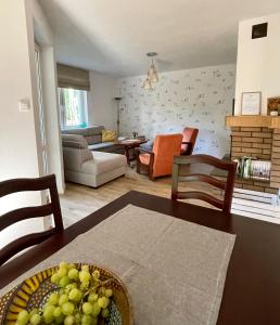 a living room with a table with a bowl of grapes at Leśnisko in Jerutki