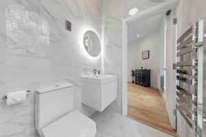 a white bathroom with a toilet and a sink at 2BR flat for 6 in Central London LR2 in London