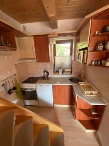 a kitchen with a sink and a stove top oven at Apartmán Donovaly Mišuty 586 in Donovaly +22 photos