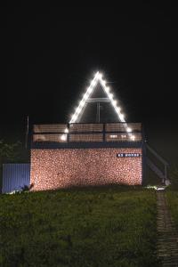 a building with lights on top of it at night at K2 House in Skole