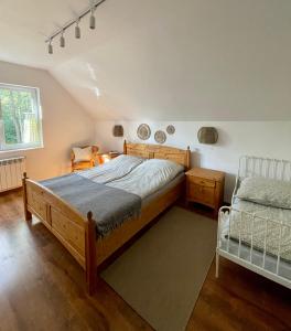 a bedroom with a bed and a crib in it at Leśnisko in Jerutki