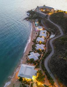 an aerial view of a beach with umbrellas and the ocean at Morningstar Buoy Haus Beach Resort at Frenchman's Reef, Autograph Collection in Nazareth