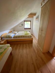 a bedroom with two beds and a closet at Apartmán Donovaly Mišuty in Donovaly