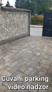 a stone patio with a stone wall and a driveway at Apartman 101 in Sarajevo