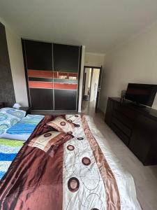 a bedroom with a bed and a dresser at Levilena apartament Osiedle Bałtyk in Grzybowo