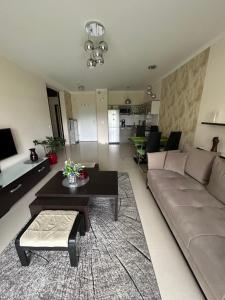 a living room with a couch and a table at Levilena apartament Osiedle Bałtyk in Grzybowo