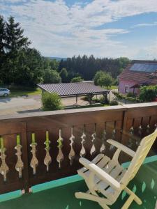 a white rocking chair on a balcony with a view at 2 Person Beedroom at Fam Herbst I Thaller in Wagerberg