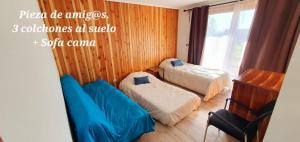 a small bedroom with two beds and a window at Casa Country Pucon in Villarrica