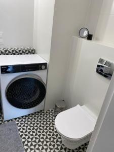 baño pequeño con aseo y microondas en RUBY Apartment- self checkin 24h, en Gdynia