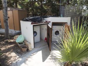 a washing machine and a washer and dryer in a yard at S.Giorgio Apartments in Sciacca