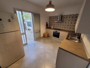 a kitchen with a refrigerator and a counter top at Donna Cecilia in Santa Maria al Bagno