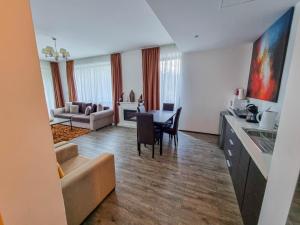 a kitchen and living room with a couch and a table at Silver Mountain G1 21 R in Poiana Brasov
