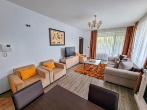 a living room with two couches and a tv at Silver Mountain G1 21 R in Poiana Brasov