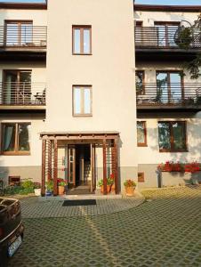 a large white building with a courtyard in front of it at Urocze Studio 7 z parkingiem in Katowice