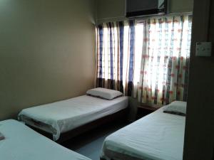 Postel nebo postele na pokoji v ubytování HotelMalaya