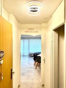 a hallway with a room with a table and a ceiling at Casa Ambizione in Dietikon