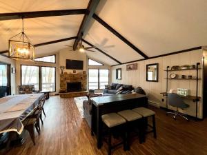 a living room with a table and a couch at Lakeside Oasis with Kayaks, Hot Tub, & Fire Pit in Clifton