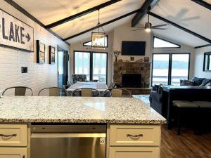 a kitchen and living room with a table and a couch at Lakeside Oasis with Kayaks, Hot Tub, & Fire Pit in Clifton