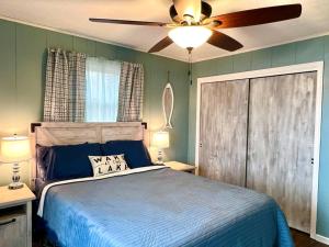a bedroom with a bed and a ceiling fan at Lakeside Oasis with Kayaks, Hot Tub, & Fire Pit in Clifton +78 photos