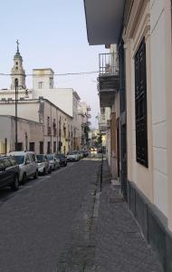 a street with cars parked on the side of a building at ArcHome in Pompei