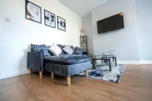 a living room with a couch and a tv at Entire House-Merseyside-Liverpool in Birkenhead