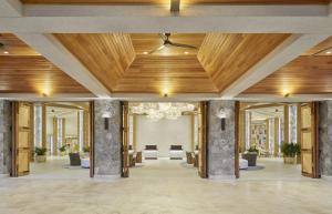 a lobby with a wooden ceiling and a hallway with chairs at The Westin Beach Resort & Spa at Frenchman's Reef in Frydendal