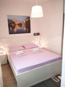 a bedroom with a bed with a white bed frame at Pansion Ponte in Mostar