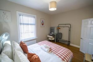 a bedroom with a white bed and a window at Entire House-Merseyside-Liverpool in Birkenhead