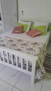 a white bed with pillows on it in a room at Villa les Alizés in Morne Blanc