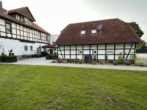 two black and white buildings with a green lawn at Pension Am Stadtrand Zerbst in Zerbst