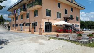 a large building with a tent outside of it at La Rosa dei Venti Apartments in Eboli