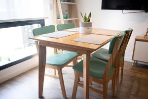 a wooden table with chairs and a plant on it at 9 DE JULIO Y OROÑO ROSARIO in Rosario