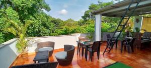 a patio with tables and chairs on a balcony at The Royal Living I Indiranagar in Bangalore