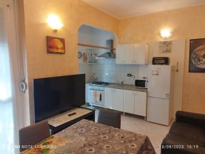 a kitchen with a refrigerator and a table in a room at vercelli holiday house in Turin