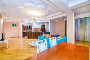 a living room with a blue couch and a table at Deluxe Apartment 142/43 in Baku