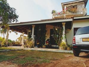 a car parked in front of a house at Sunrise Eco Resort in Matara
