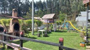 a park with a playground with a slide at Espectacular cabaña campestre con granja in Zipaquirá